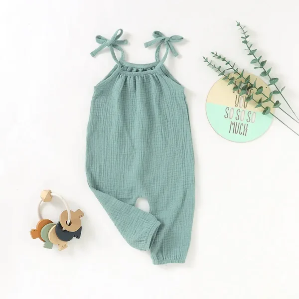 A baby 's outfit with a wooden toy and a stuffed animal.