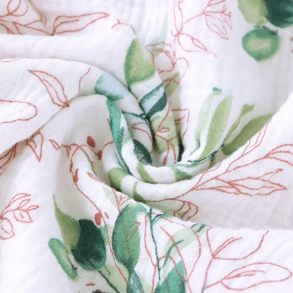 A close up of the fabric with leaves and flowers